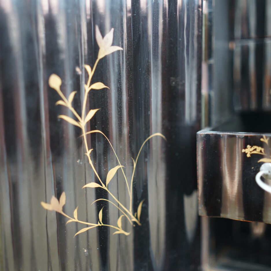 Cabinet en bois laqué noir à motifs de faucon et pins, branchages... en hira maki-e à huit tiroirs et deux portes.